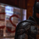 Robert Pattinson brooding in costume as Batman in The Batman.
